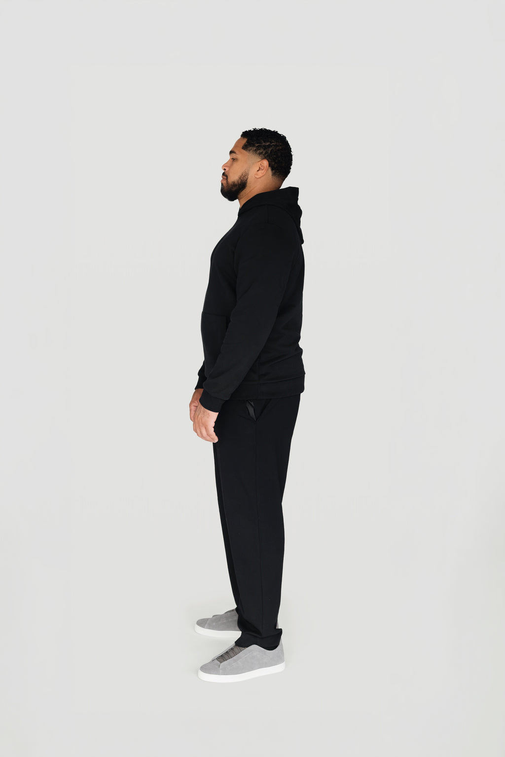 Side view of the black Le Butin8 Believe hoodie