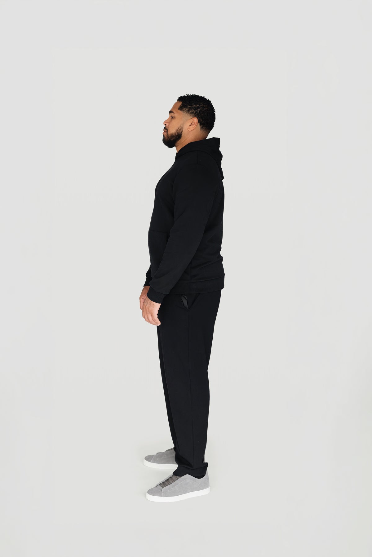 Side view of the black Le Butin8 Believe hoodie